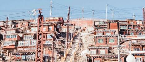 A densely packed urban area with closely built structures and visible utility poles.