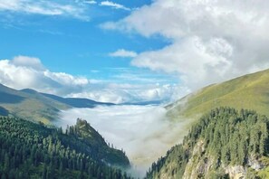 A valley with dense forested hills and a clear sky. - Crown Boutique Hotel (Sertar)