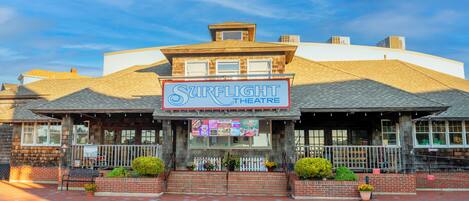 A building with a sign reading "Surflight Theatre" and a brick facade.