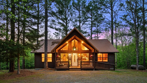 A log cabin with a front porch, a central door, and a chimney. - Couple's Escape | Hot Tub | Fire Pit (Broken Bow)