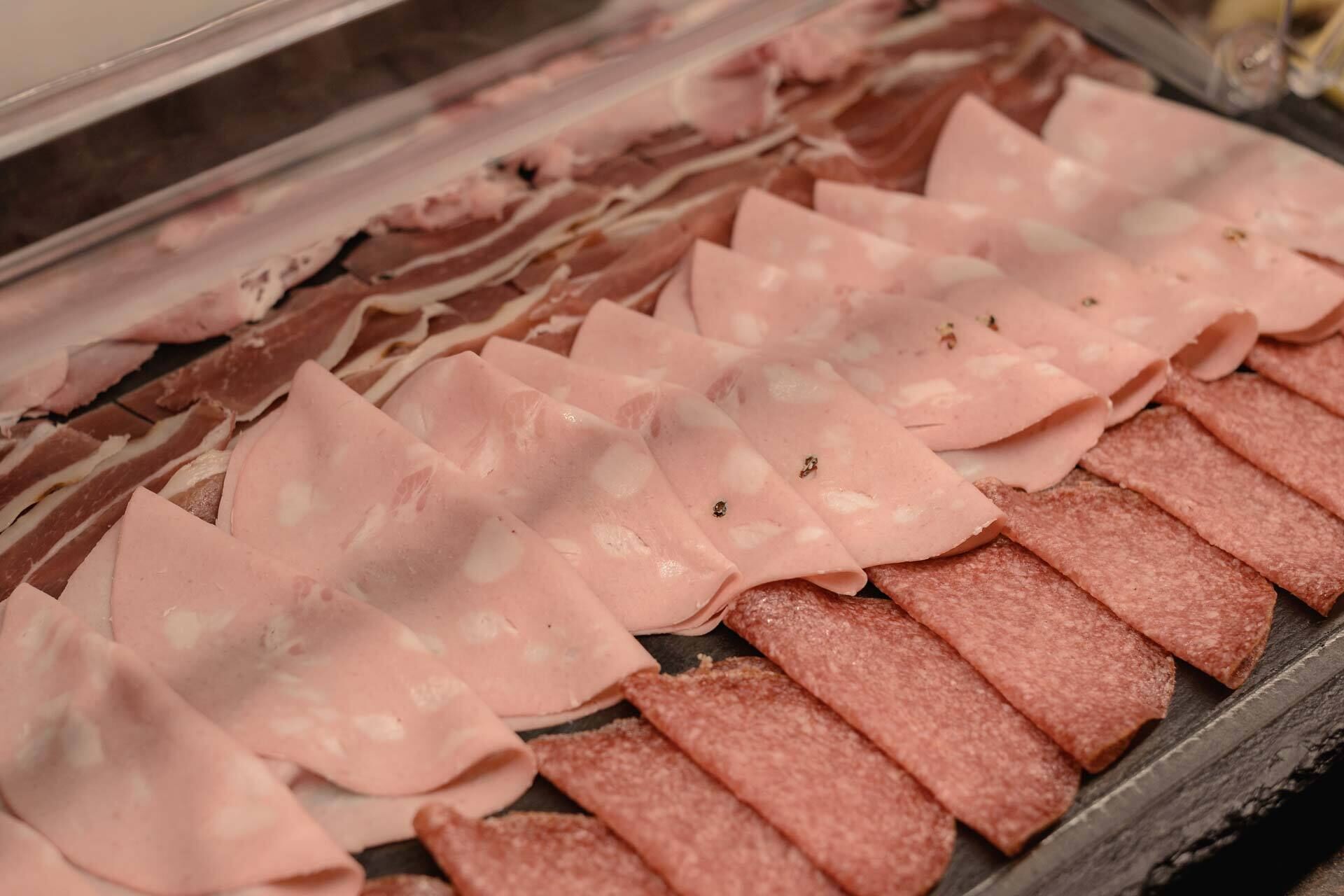 Eine Auswahl an geschnittenem Fleisch in einer Kühlvitrine.