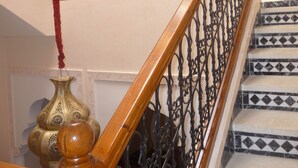 A staircase with ornate black iron railings and a wooden handrail. - MARRAKECH RYAD ALL COMFORTS IN A RESIDENCE WITH 3 LARGE SWIMMING POOLS (Marrakech)