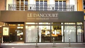 The exterior of Le Dancourt Restaurant, featuring a modern facade, large windows, and a visible entrance. - Chambres Dancourt (Charmes)
