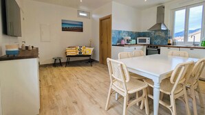 A modern kitchen with a dining area, wooden flooring, and a view of the outdoors. - Penthouse with large terrace, near beaches (Toulon)