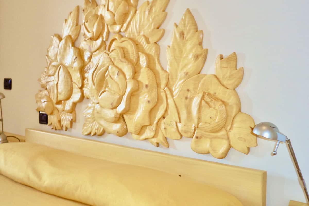 A wall-mounted decorative panel with floral designs.
