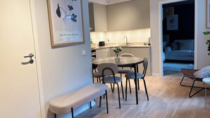Una cocina moderna con comedor, un banco y una obra de arte enmarcada en la pared.