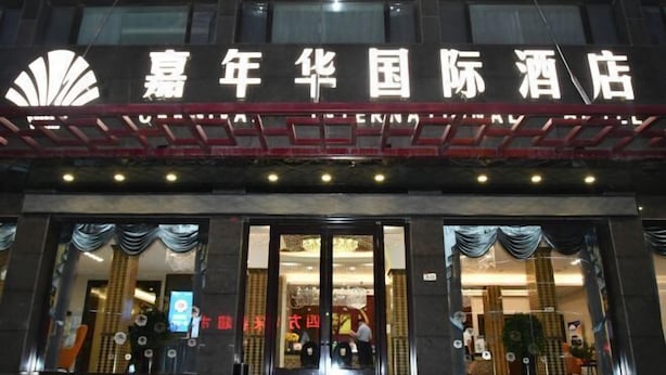 A hotel entrance with a large sign and decorative curtains. - Dunhuang Carnival International Hotel (Shazhou Night Market) (Dunhuang)