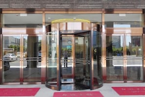 A revolving door entrance with glass panels and a metal frame. - GreenTree Inn (Shanghai Jiangyue Road Metro Station) (Shanghai)