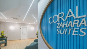 A modern interior with a sign reading "CORAL ZAHARA SUITES".