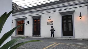 A building with a sign reading "Pasco Colonial." - Paseo Colonial - Leo's Favorite (Santo Domingo)