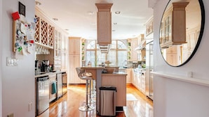 A modern kitchen with wooden cabinets, stainless steel appliances, and a central island.