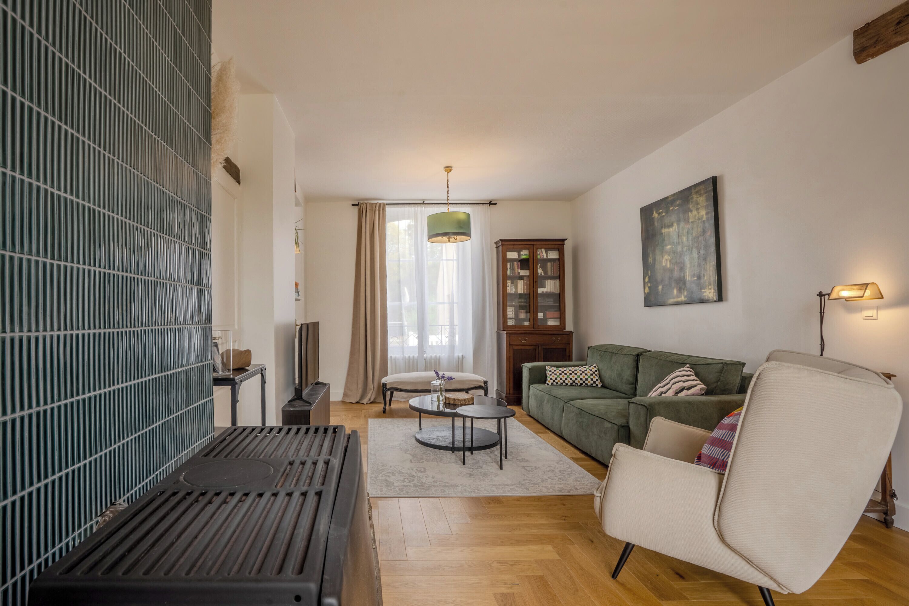 A living room with a sofa, armchair, and a coffee table.