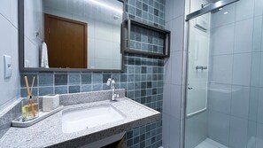 A bathroom with a sink, mirror, and shower. - Malia Beach Experience  (Ipojuca)