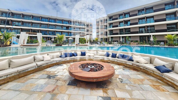 A hotel pool area with a circular seating arrangement and a fire pit. - Malia Beach Experience  (Ipojuca)