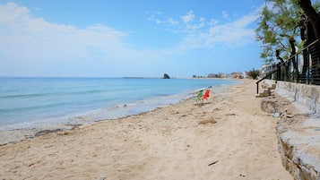On the beach, white sand, beach umbrellas, beach towels