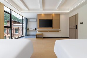 A modern hotel room with a large window, a flat-screen TV mounted on the wall, and a wooden bench. - Chujian Inn (Xiaojin)