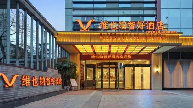 The Vienna Classic Hotel entrance with a modern facade and illuminated signage. - Vienna Classic Hotel (Kuanzhai Alley Luomashi Subway Station) (Chengdu)