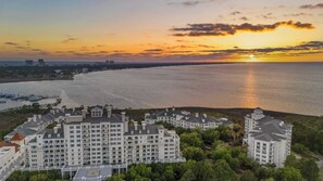 A large, multi-story hotel with a central courtyard, located near a waterfront with boats docked. - Studio Condo in Luxe Sandestin Resort w/ Balcony, Pool, + Walk to Baytowne Wharf (Miramar Beach)