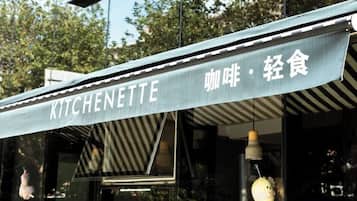 A restaurant sign with the name "KITCHENETTE" and Chinese characters for "snack" and "light food".