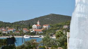 A coastal town with a prominent church, a beach, and a hill in the background.