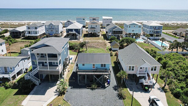 A coastal residential area with multiple two-story houses, some with balconies and waterfront views.