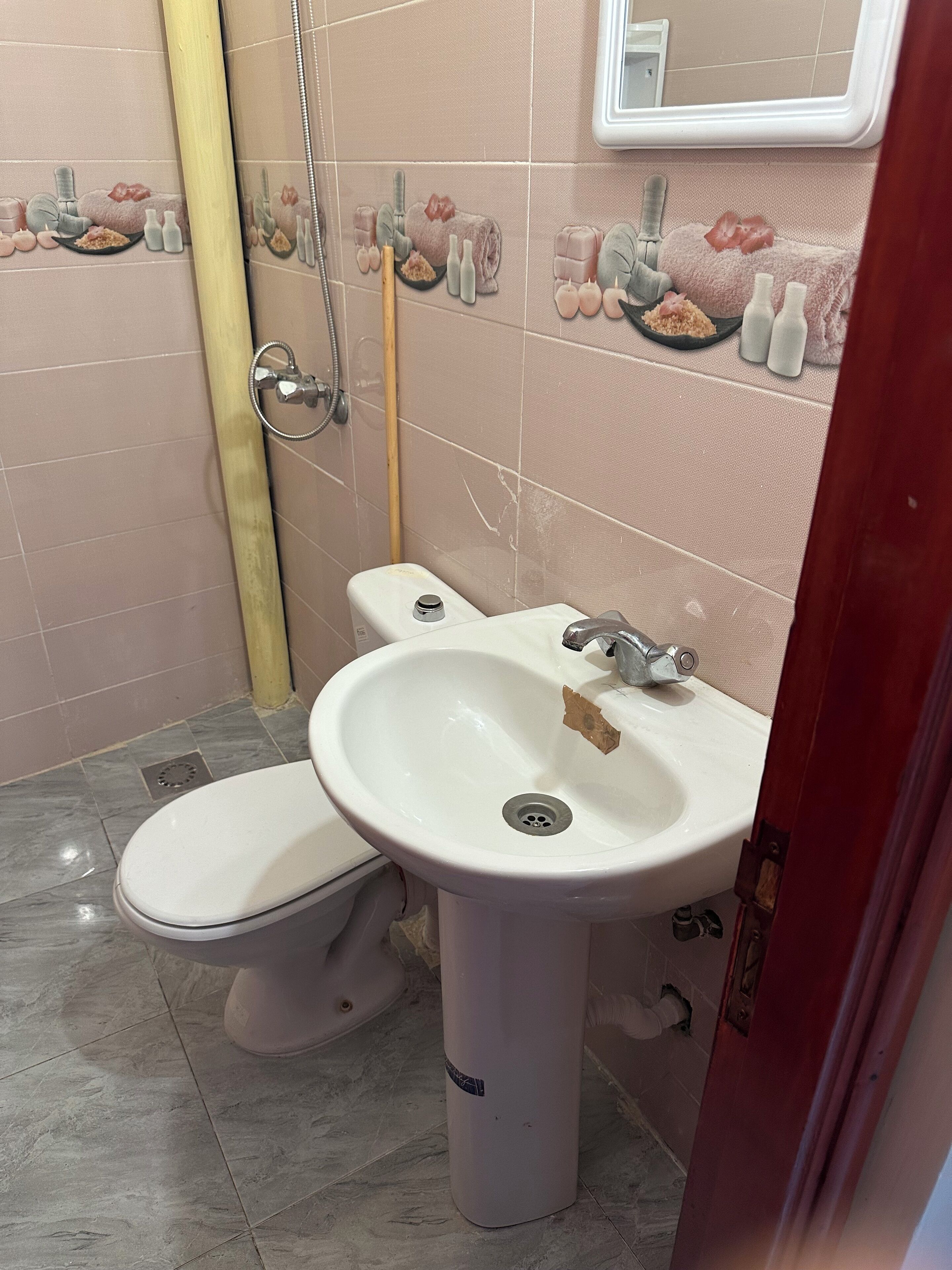Un baño con inodoro, lavabo y ducha.