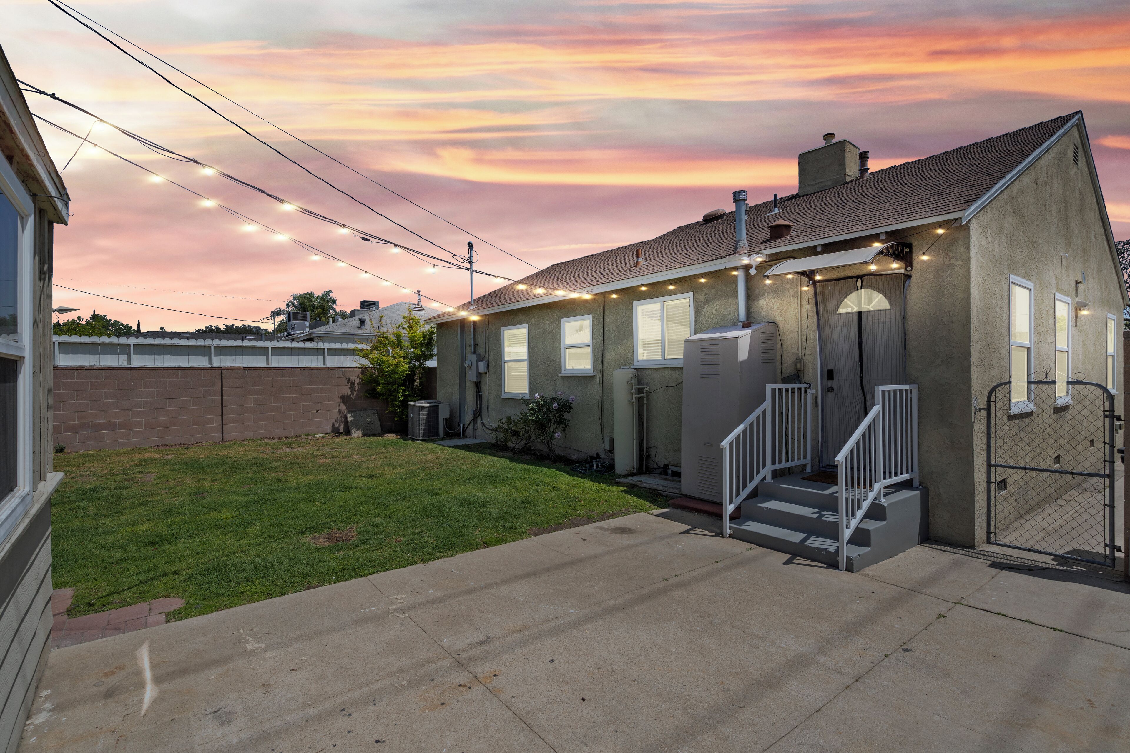 A single-story house with a front porch, a small front yard, and a garage.