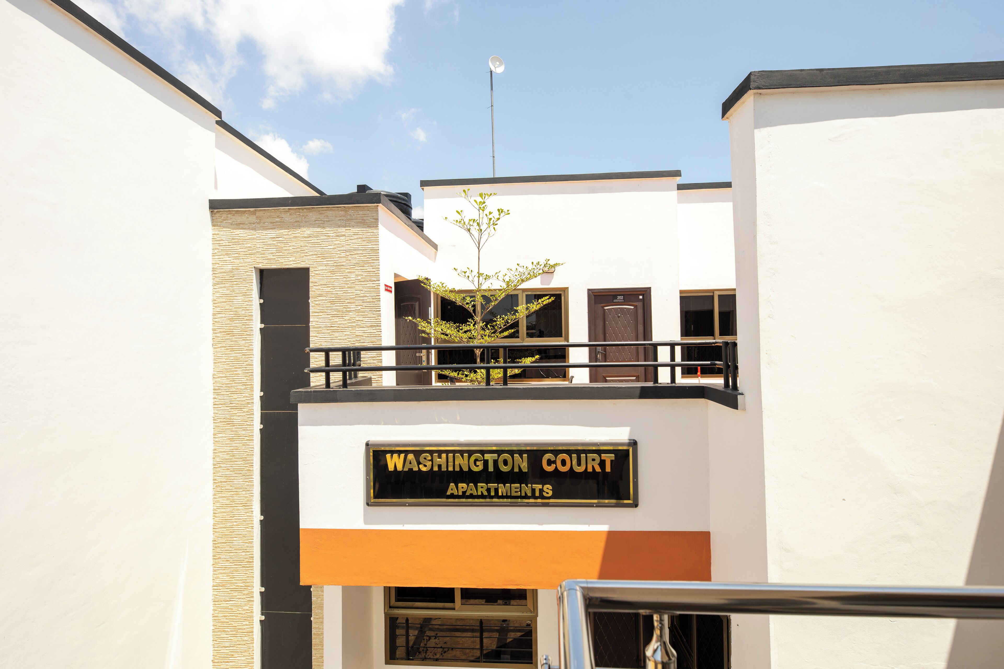 A building with a sign reading "Washington Court Apartments."