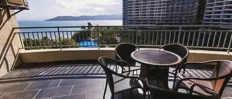 Enjoy breathtaking views of the water and surrounding landscape from this balcony.