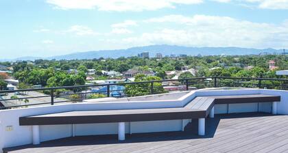 Resort like accommodations in Kingston with WiFi, AC, Pool and Rooftop. King bed