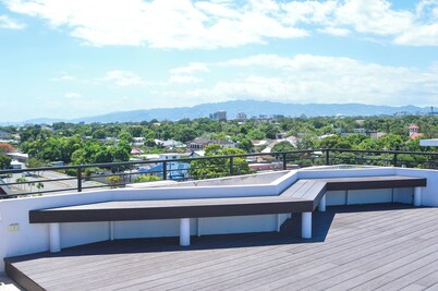 Resort like accommodations in Kingston with WiFi, AC, Pool and Rooftop. King bed