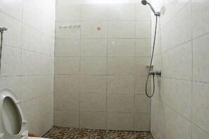 A small, tiled bathroom with a shower and toilet. - Ningbo Ivory Guest Youth Hostel (Ningbo)