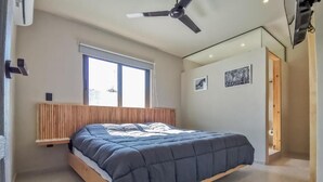 A bedroom with a bed, a ceiling fan, a window, and a door. - CASA ULA - Cancun (Cancun)
