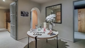 A modern interior with a round table displaying the text "Casa Ula," a mirror with the phrase "You Are," and a photograph on the wall. - CASA ULA - Cancun (Cancun)