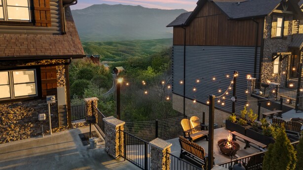 A residential property with a stone facade, wooden exterior, and a view of a mountainous landscape. - Million $ View|Pool Table|Indr Pool|Games (Sevierville)