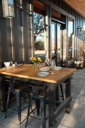An outdoor wooden table with chairs, a vase of flowers, and a bowl of bread. - Juniper Hideaway- Nature Retreat Near Zion & Bryce (Cedar City)