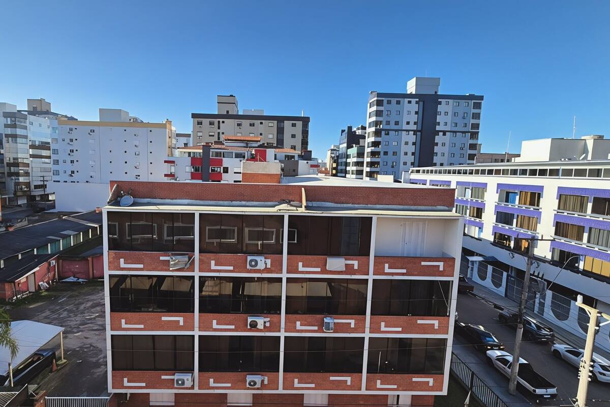 A multi-story building with a modern architectural design, featuring a central courtyard and a mix of residential and commercial spaces.