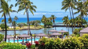 A resort with a pool, palm trees, and a view of the ocean. - Mauna Lani Resort  Terrace - G301 - BEST VIEWS - Updated - Owners Club Access (Kamuela)