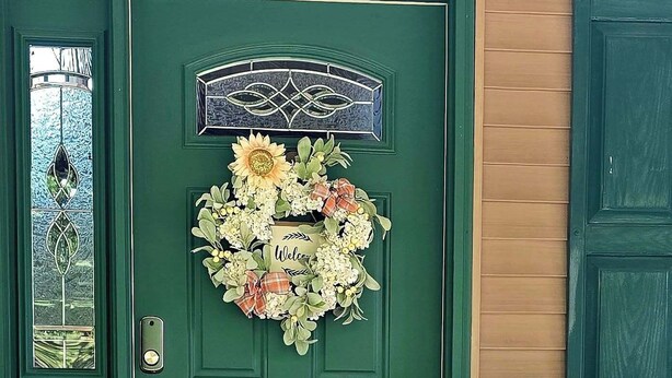A green door with a floral wreath and a bear statue. - Romantic couples getaway in awesome Bluford with WiFi, Fireplace, and Game Room (Bluford)