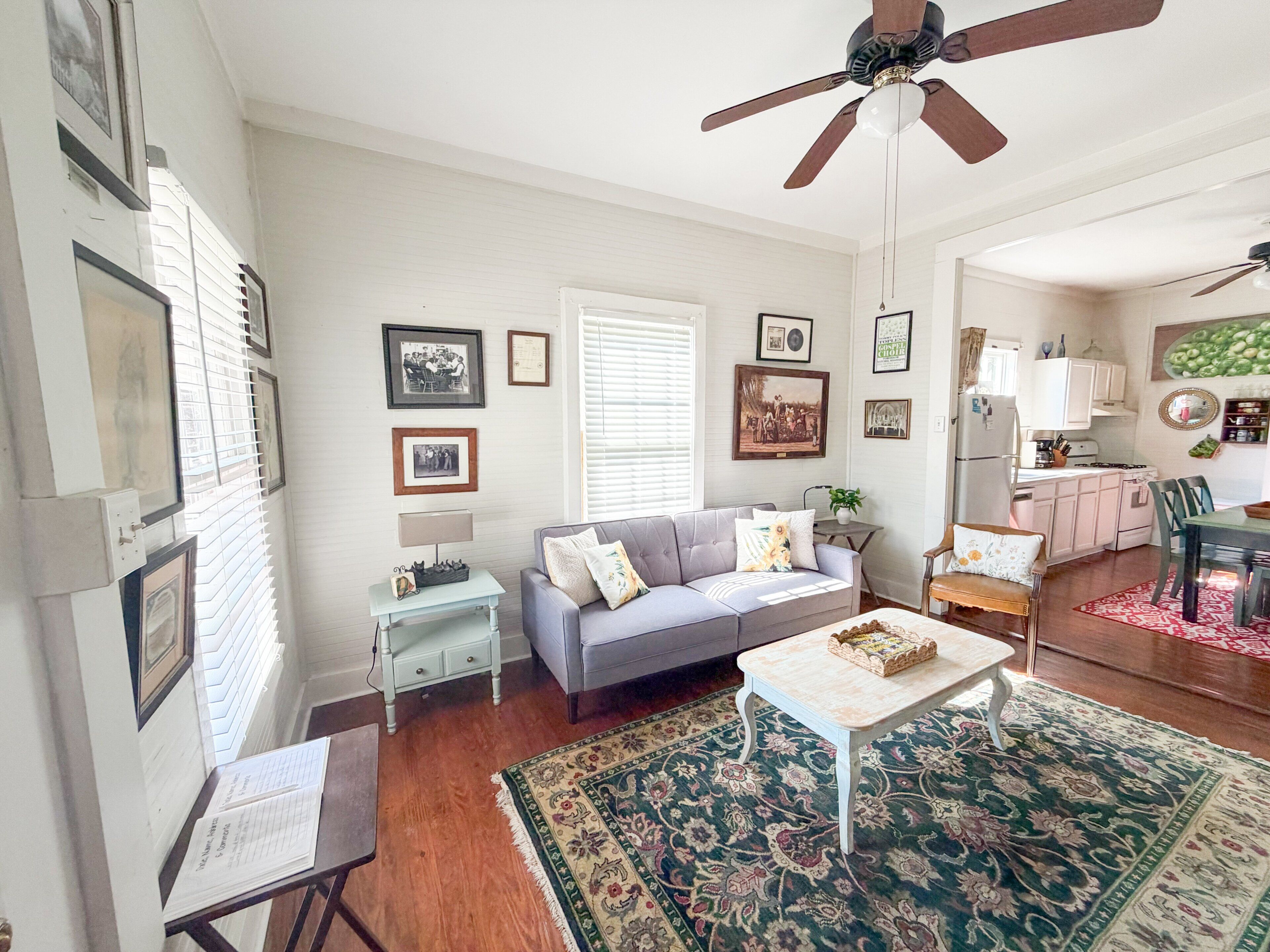 A living room with a sofa, coffee table, and a patterned rug.