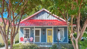 A small, single-story house with a red roof, a front porch with two chairs, and a mailbox. - Shanty Bellum Too | 2/1, Washer/Dryer, Full Kitchen (Natchez)