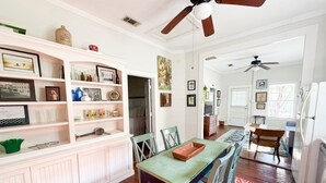 A spacious kitchen with a dining area, wooden cabinets, and a ceiling fan. - Shanty Bellum Too | 2/1, Washer/Dryer, Full Kitchen (Natchez)