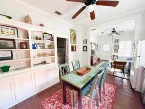 A spacious kitchen with a dining area, wooden cabinets, and a ceiling fan. - Shanty Bellum Too | 2/1, Washer/Dryer, Full Kitchen (Natchez)