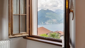 A window with a view of a mountain and a lake.