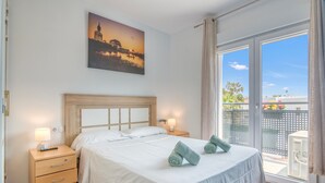 A bedroom with a bed, a nightstand, a drawer unit, and a painting on the wall. - Villa 'Farau' with Sea View, Wi-Fi and Air Conditioning (Calpe)