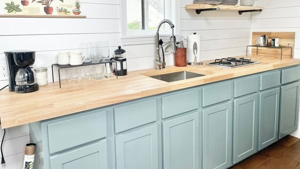 A kitchen with a wooden countertop, a sink, a coffee maker, and a window. - The Tiny with Big Time Vibes and Walkability (Austin)