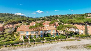 A residential area with terraced houses, a clear sky, and a hilly landscape in the background. - Les Boucaniers by Interhome (Sainte Maxime)