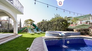 A pool area with a slide, lounge chairs, and a small play structure. - Spacious House with Pool (Atlatlahucan)