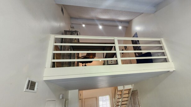 A room with a white balcony railing, a window, and a door. - Charming 2-bedroom home with fenced yard sleeps 6 in Baton Rouge near Tigerland (Baton Rouge)