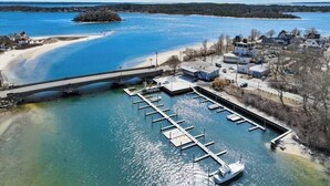 A marina with docks, a bridge, and a small island in the background. - Beach, Breeze & Bunk Beds. FamilyFun Steps to the Shore. Dog-Friendly, GameWall. (Wareham)
